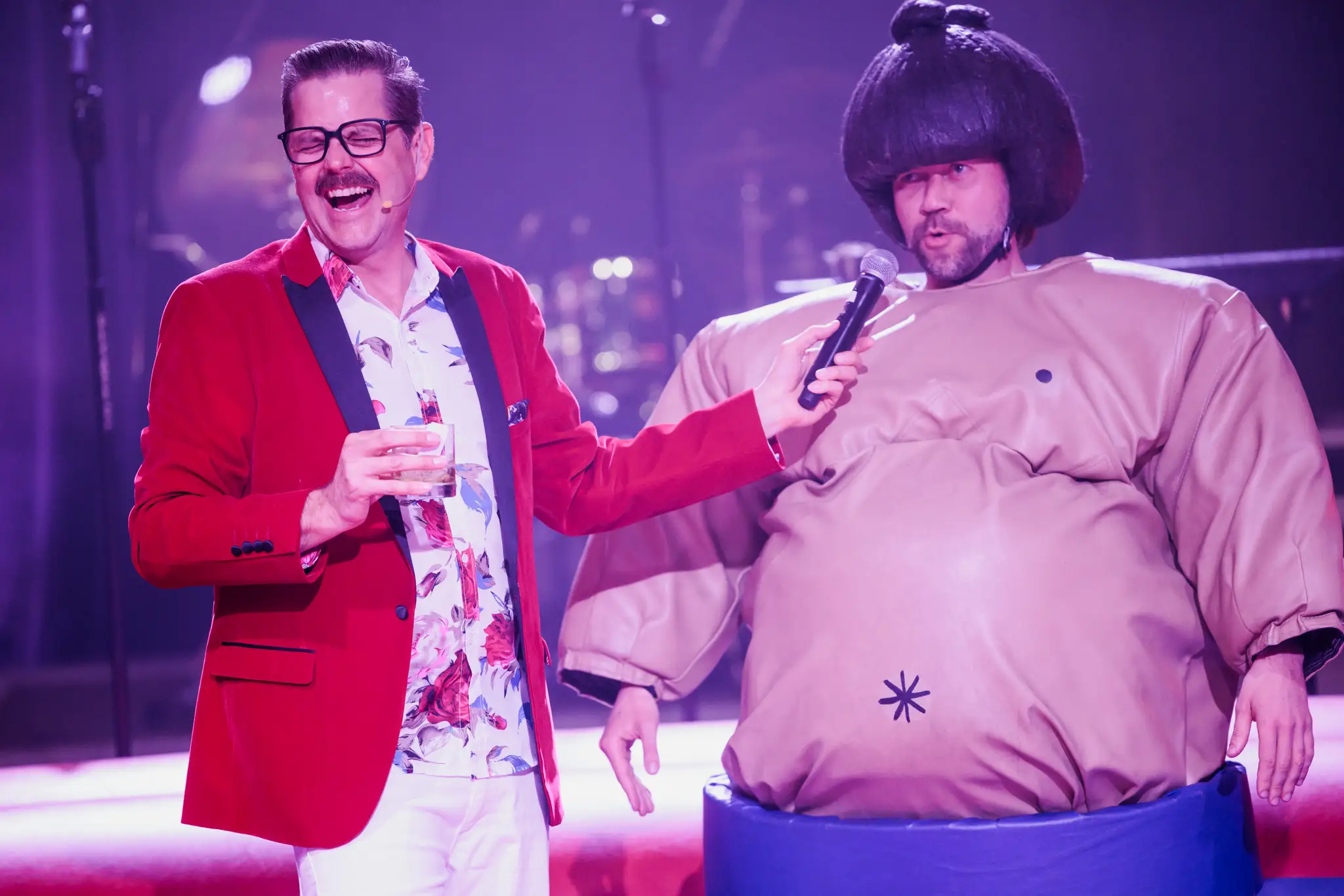 Cliff interviewing a person in a sumo wrestler costume